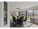 Sunroom dining area with glass enclosure and slate tile floor at 3745 Hillview Ct, Land O Lakes, FL 34639