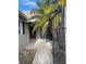 Front entry with walkway, palm tree, and gate at 439 Boca Ciega Point N Blvd, St Petersburg, FL 33708