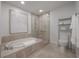 Spa-like bathroom with soaking tub, walk-in shower, and modern fixtures at 450 Knights Run Ave # 415, Tampa, FL 33602