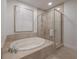 Spa-like bathroom featuring a soaking tub and glass shower at 450 Knights Run Ave # 415, Tampa, FL 33602