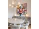 Modern dining area with round table, statement art, and chandelier at 450 Knights Run Ave # 415, Tampa, FL 33602