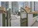 Green gate opening to a courtyard with stairs and a fountain at 450 Knights Run Ave # 415, Tampa, FL 33602