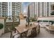 Spacious patio with seating area and dining table, surrounded by city views at 450 Knights Run Ave # 415, Tampa, FL 33602