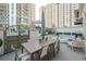 Spacious patio with dining table and seating area, perfect for outdoor entertaining at 450 Knights Run Ave # 415, Tampa, FL 33602