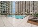 Resort-style pool with lounge chairs and modern building at 450 Knights Run Ave # 415, Tampa, FL 33602