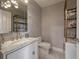 Elegant powder room with marble vanity, gold fixtures, and stylish shelving at 450 Knights Run Ave # 415, Tampa, FL 33602