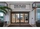 Stunning entrance to The Plaza Harbour Island building, featuring sleek glass doors and manicured landscaping at 450 Knights Run Ave # 415, Tampa, FL 33602