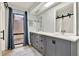 Modern bathroom with dual vanity, gray cabinets, and a quartz countertop at 4604 Westford Cir, Tampa, FL 33618