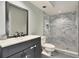 Modern bathroom with gray tile shower and vanity at 4604 Westford Cir, Tampa, FL 33618