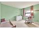 Light green bedroom with window, chair, and dresser at 4604 Westford Cir, Tampa, FL 33618