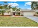 Single-story house with stone accents and a two-car garage at 4604 Westford Cir, Tampa, FL 33618