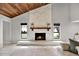 Living room fireplace with white stone facade and wooden mantel at 4604 Westford Cir, Tampa, FL 33618