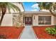 Double front doors with stone accents and a walkway at 4604 Westford Cir, Tampa, FL 33618