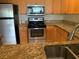 Kitchen with granite countertops and stainless steel appliances at 5125 Palm Springs Blvd # 10303, Tampa, FL 33647