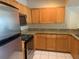 Kitchen with wood cabinets and granite countertops at 5125 Palm Springs Blvd # 10303, Tampa, FL 33647