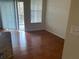 Living room with wood floors and sliding glass doors at 5125 Palm Springs Blvd # 10303, Tampa, FL 33647