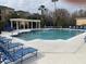 Relaxing community pool with surrounding lounge chairs at 5125 Palm Springs Blvd # 10303, Tampa, FL 33647