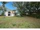 Large backyard with lush grass and mature trees at 5147 Sterling Manor Dr, Tampa, FL 33647