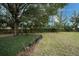 Landscaped backyard with a row of potted plants at 5147 Sterling Manor Dr, Tampa, FL 33647