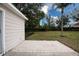 Landscaped backyard with patio and large grass area at 5147 Sterling Manor Dr, Tampa, FL 33647