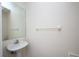 Simple bathroom with pedestal sink and mirror at 5147 Sterling Manor Dr, Tampa, FL 33647