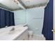 Clean bathroom with blue walls, shower, and single sink vanity at 5147 Sterling Manor Dr, Tampa, FL 33647