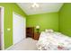 Bedroom with lime green walls, ceiling fan and ample closet space at 5147 Sterling Manor Dr, Tampa, FL 33647