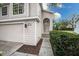 Front entrance with walkway, landscaping, and attached garage at 5147 Sterling Manor Dr, Tampa, FL 33647