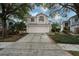 Two-story house with attached garage and landscaping at 5147 Sterling Manor Dr, Tampa, FL 33647