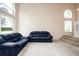 Living room with vaulted ceiling, large windows, and staircase at 5147 Sterling Manor Dr, Tampa, FL 33647