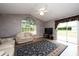 Living room features vaulted ceiling, hardwood floors, and sliding glass doors at 5147 Sterling Manor Dr, Tampa, FL 33647