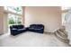 Living room with vaulted ceiling, large windows, and staircase at 5147 Sterling Manor Dr, Tampa, FL 33647