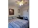 Main bedroom with patterned bedding and ceiling fan at 5745 40Th N Ave # 152B, St Petersburg, FL 33709