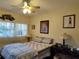 Bright bedroom with a queen-size bed and ceiling fan at 5745 40Th N Ave # 152B, St Petersburg, FL 33709