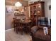 Cozy dining area with wood table, chairs, and a comfy recliner at 5745 40Th N Ave # 152B, St Petersburg, FL 33709