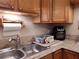 Simple kitchen with wood cabinets and double sink at 5745 40Th N Ave # 152B, St Petersburg, FL 33709