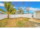 Fenced backyard with a grassy area and palm tree at 5810 Town N Country Blvd, Tampa, FL 33615