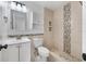 Clean bathroom with a mosaic-tiled shower and white vanity at 5810 Town N Country Blvd, Tampa, FL 33615