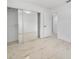 Well-lit bedroom with mirrored closet doors and tile flooring at 5810 Town N Country Blvd, Tampa, FL 33615