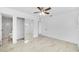 Bright bedroom with tile floors, mirrored closet doors, and ceiling fan at 5810 Town N Country Blvd, Tampa, FL 33615