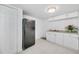 Galley-style kitchen with white cabinets and granite countertop at 5810 Town N Country Blvd, Tampa, FL 33615