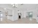 Open concept living area with tile floors, white walls, and modern kitchen at 5810 Town N Country Blvd, Tampa, FL 33615