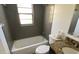 Clean bathroom with a bathtub and granite vanity at 6802 Seaview Way, Tampa, FL 33615