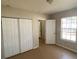 Bedroom with double door closet and window at 6802 Seaview Way, Tampa, FL 33615