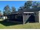 Rear view of house showing screened patio and yard at 6802 Seaview Way, Tampa, FL 33615