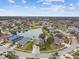 Aerial view of the house and community, showcasing a lake at 6944 Runner Oak Dr, Wesley Chapel, FL 33545