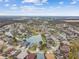 Aerial view of neighborhood with lake and houses at 6944 Runner Oak Dr, Wesley Chapel, FL 33545