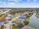 Aerial view of a residential neighborhood with houses and a lake at 6944 Runner Oak Dr, Wesley Chapel, FL 33545