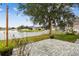 Brick paved patio, fenced backyard, and lake view at 6944 Runner Oak Dr, Wesley Chapel, FL 33545