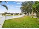 Spacious backyard with a white fence and lake view at 6944 Runner Oak Dr, Wesley Chapel, FL 33545